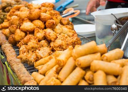 Delicious of traditional asian cuisine. Hot fried snacks at street market