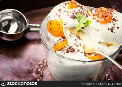 Delicious orange icecream. Vanilla ice cream in bowl with orange jam