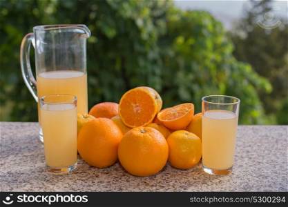 delicious orange juice and oranges in the garden
