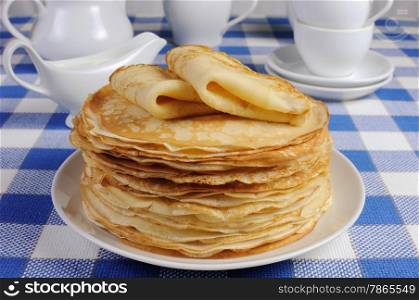 delicious pancakes on a plate with milk sauce
