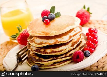 delicious pancakes on morning breakfast table with fruits