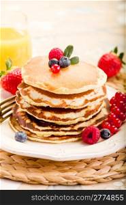 delicious pancakes on morning breakfast table with fruits