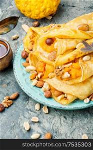 Delicious pancakes stuffed with pumpkin and nut.Autumn dessert.Homemade crepes. Pancakes stuffed with pumpkin