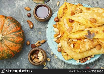 Delicious pancakes stuffed with pumpkin and nut.Autumn food.Homemade crepes. Pancakes stuffed with pumpkin