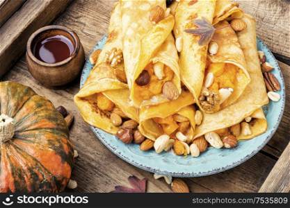 Delicious pancakes stuffed with pumpkin and nut.Autumn food. Pancakes stuffed with pumpkin