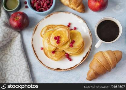 delicious pancakes with berries with croissant and a cup of coffee breakfast