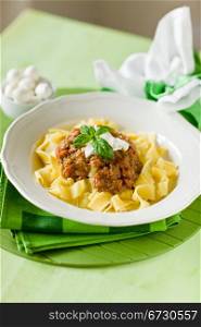 delicious pasta with tomato meat sauce and mozzarella chips over it