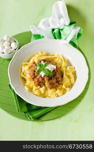 delicious pasta with tomato meat sauce and mozzarella chips over it