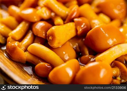 Delicious pickled mushrooms. Macro background. High quality photo. Delicious pickled mushrooms. Macro background.