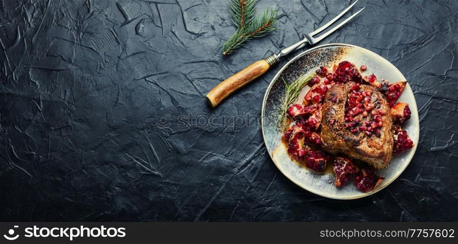 Delicious piece of meat fried with pomegranate. Space for text. Recipe place. Pork meat fried with pomegranate