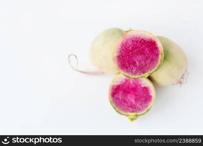 Delicious pink radish in the cut of the dragon&rsquo;s eye variety on a white background. Delicious pink radish in the cut of the dragon&rsquo;s eye variety on a white background.