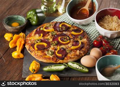 Delicious pizza served on wooden table. Pizza cooking ingredients