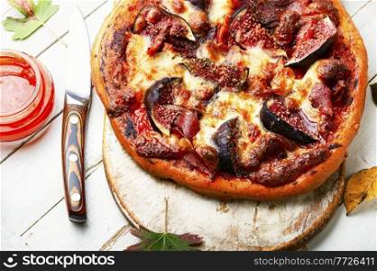 Delicious pizza with bacon and autumn figs.Fast food. Tasty meat pizza with fig