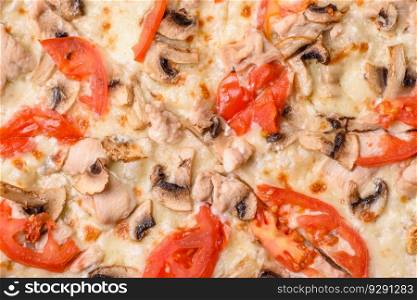 Delicious pizza with chicken, tomatoes and cheese with salt and sauce on a dark concrete background
