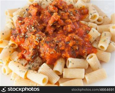 Delicious plate of macaroni with tomato close up