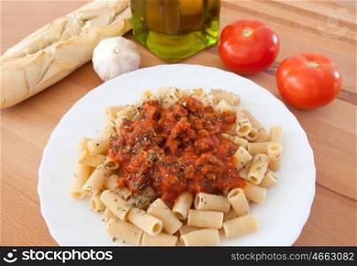 Delicious plate of macaroni with tomato ingredients background
