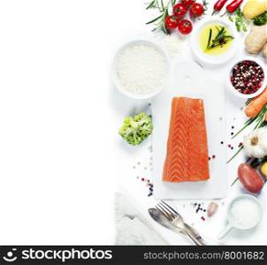 Delicious portion of fresh salmon fillet with aromatic herbs, spices and vegetables - healthy food, diet or cooking concept. Top view.