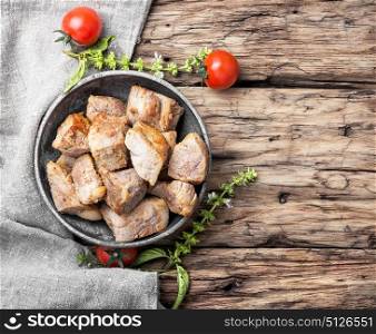 Delicious portion roast pork meat. Stew meat.Juicy pieces of fried pork steak meat in a stylish dish.Top view