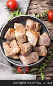 Delicious portion roast pork meat. Stew meat.Juicy pieces of fried pork steak meat in a stylish dish.Top view