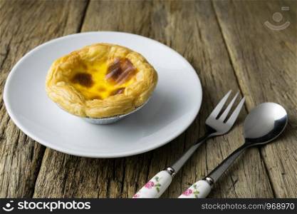 delicious portuguese egg tart on wood background
