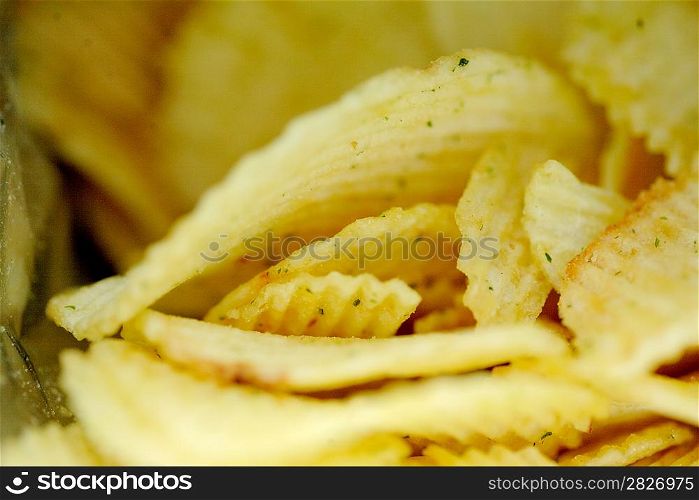 Delicious potato chips closeup on the black