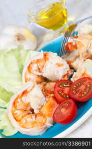 Delicious prawn salad served on a blue plate