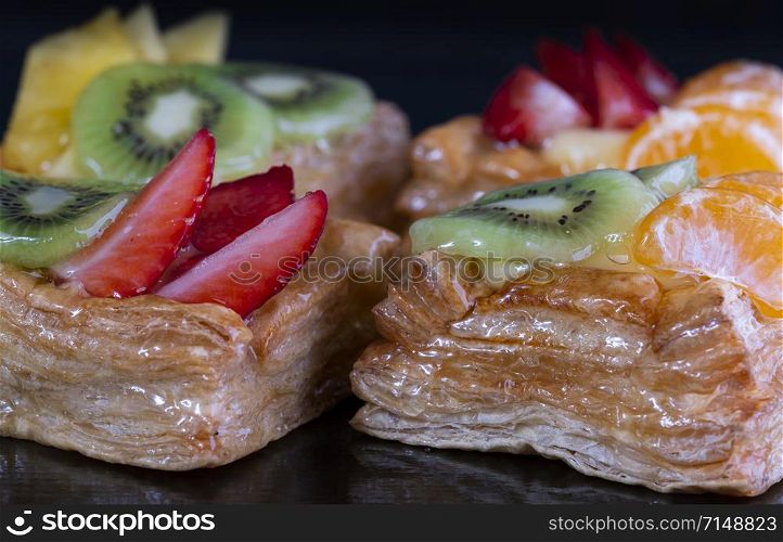 Delicious puff pastry with cream and fruits
