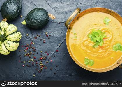 Delicious pumpkin soup and autumn pumpkins.Seasonal autumn food. Autumn pumpkin soup