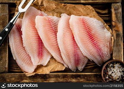 Delicious raw fish fillet on a wooden tray. Macro background. High quality photo. Delicious raw fish fillet on a wooden tray.