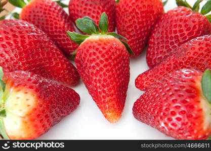 Delicious red strawberries on a white plate