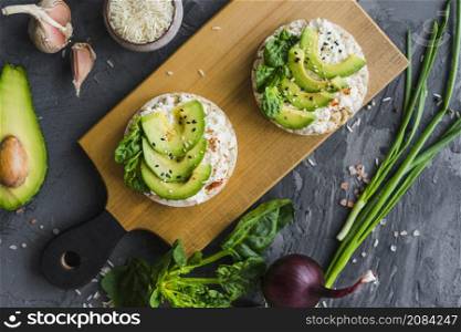 delicious rice cake with cream cheese avocado wooden board with organic vegetables