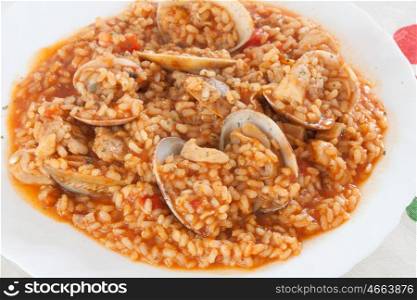 Delicious rice dish with clams sprinkled with parsley&#xA;