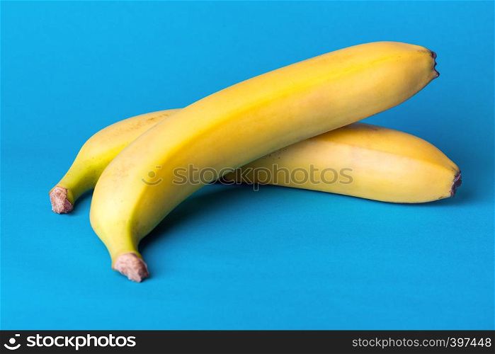 delicious ripe bananas on a blue background