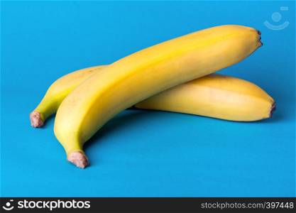 delicious ripe bananas on a blue background