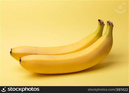 delicious ripe bananas on a yellow background