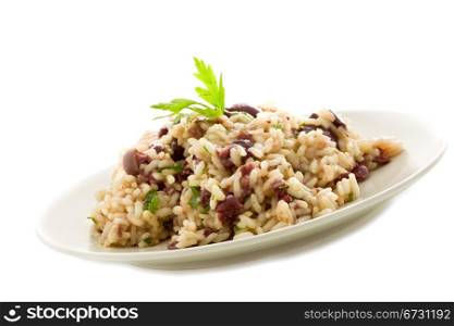delicious risotto with black olives on white isolated background