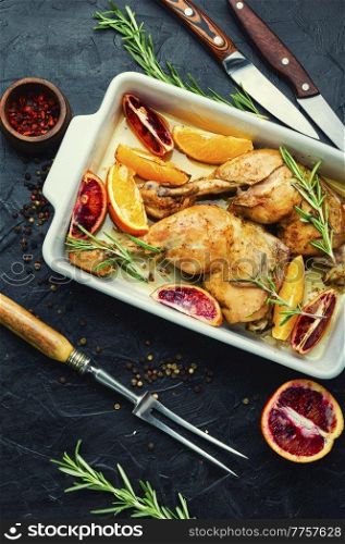 Delicious roasted chicken meat with citrus fruits. Baked chicken legs in a baking dish. Baked chicken legs with oranges