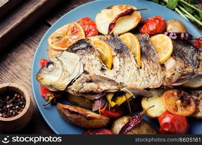 Delicious roasted fish with lemon and garnish. Grilled delicious fish