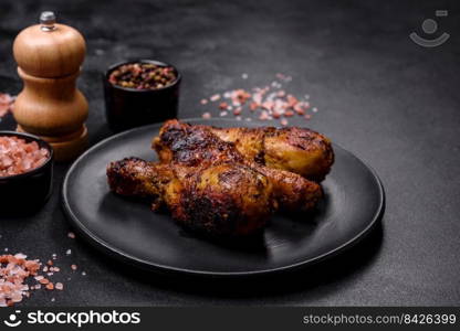 Delicious ruddy grilled chicken legs with spices and herbs. Cooking food over an open fire. Delicious ruddy grilled chicken legs with spices and herbs