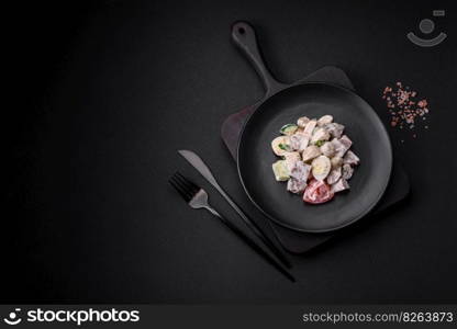 Delicious salad with boiled beef tongue, quail eggs, tomatoes and cucumber on a dark concrete background