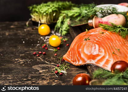 Delicious salmon fillet with aromatic herbs and spices on dark wooden background. Healthy food cooking concept. Close up