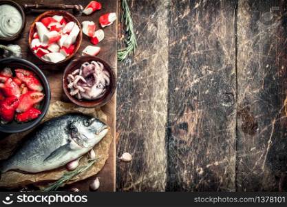 Delicious seafood on the board. On a wooden background.. Delicious seafood on the board.