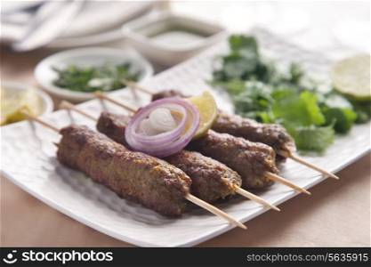 Delicious seekh kabab served in plate at table