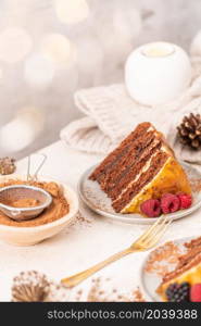 Delicious semi-naked chocolate cake with caramel topping and decorated with blackberries and raspberries. Light background