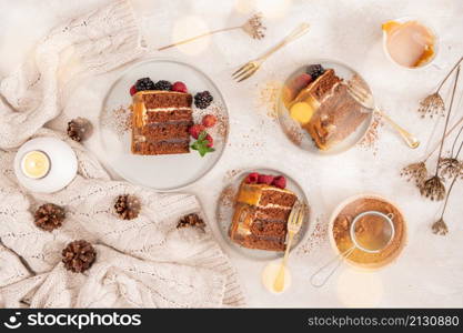 Delicious semi-naked chocolate cake with caramel topping and decorated with blackberries and raspberries. Light background