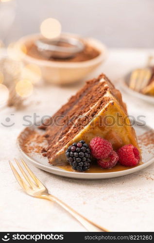 Delicious semi-naked chocolate cake with caramel topping and decorated with blackberries and raspberries. Light background