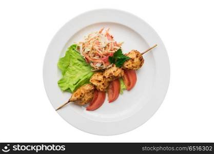 Delicious shish kebab. Delicious chicken shish kebab on skewers with vegetables at plate isolated on a white background