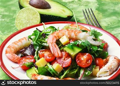 delicious shrimp salad and avocado with tomato. spring salad with large shrimp,avocado,cherry tomato and greens
