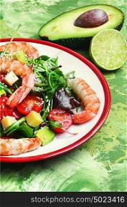 delicious shrimp salad and avocado with tomato. spring salad with large shrimp,avocado,cherry tomato and greens