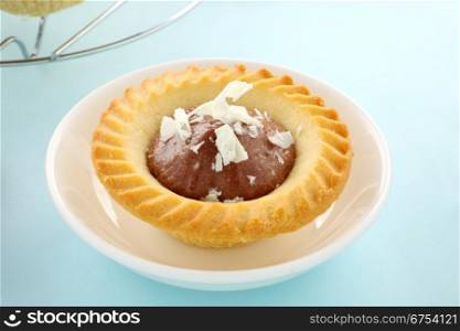 Delicious single chocolate tart in a dish ready to serve.